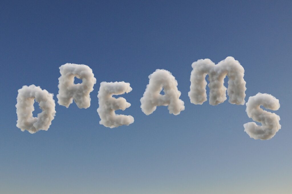 wolken in de vorm van letters die het woord dreams spellen.